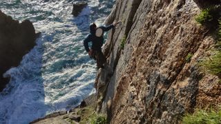 how to start sea cliff climbing: climber on a cliff