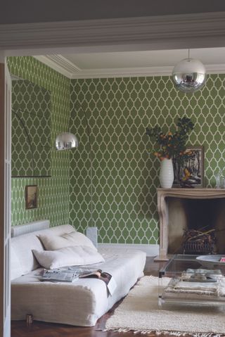 A green modern living room idea using Farrow and Ball's Tessella wallpaper decor