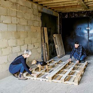 garage with wooden pallets and men and women