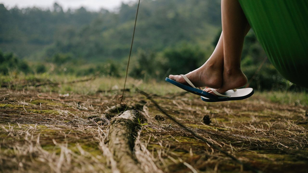 Best flip flops for walking: person with flip flops sitting in a tent