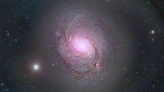 At the heart of the nearby spiral galaxy NGC 1068, researchers found a thriving &#039;factory&#039; of ghostly particles called neutrinos.