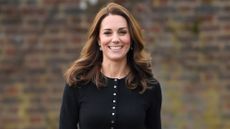 Catherine, Princess of Wales, wearing a black cardigan, hosts a Christmas party for families of military personnel deployed in Cyprus at Kensington Palace on December 4, 2018 