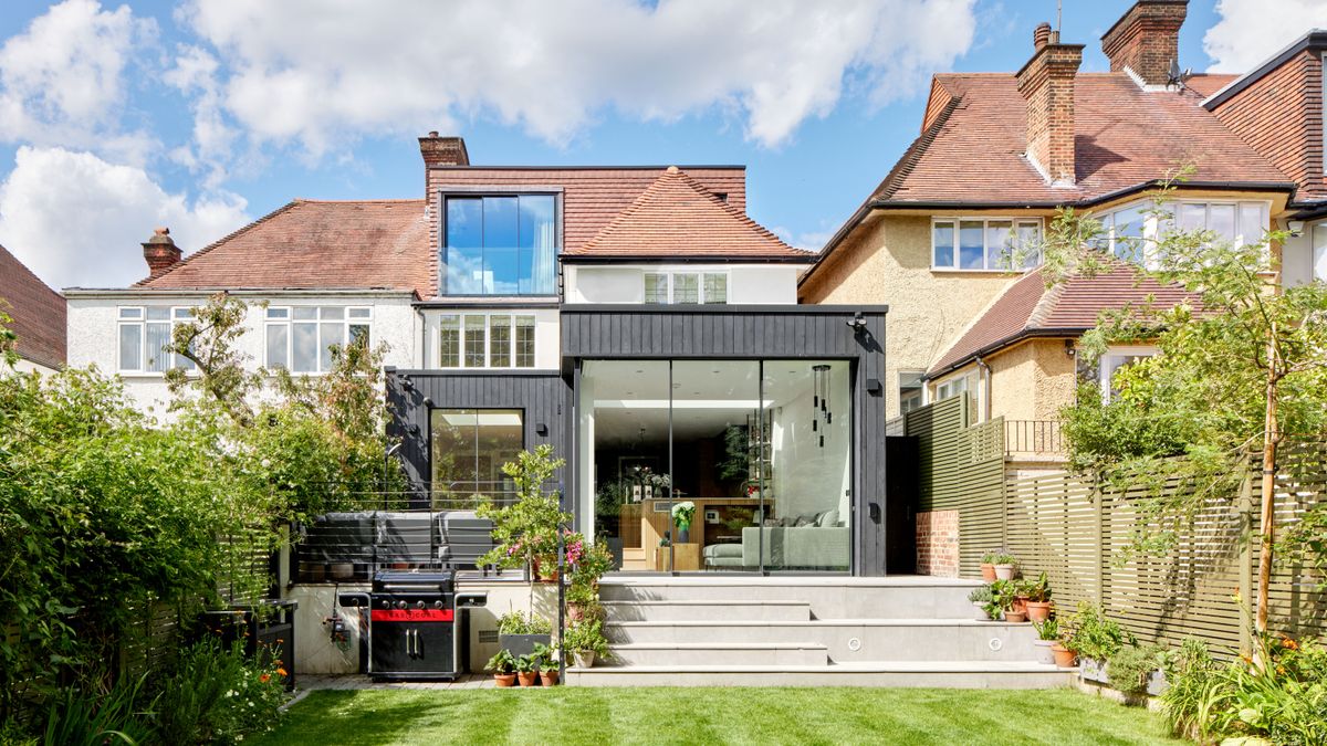 rear and side black clad house extension with added second storey extension