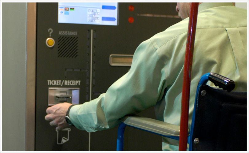 man receiving receipt from parking machine