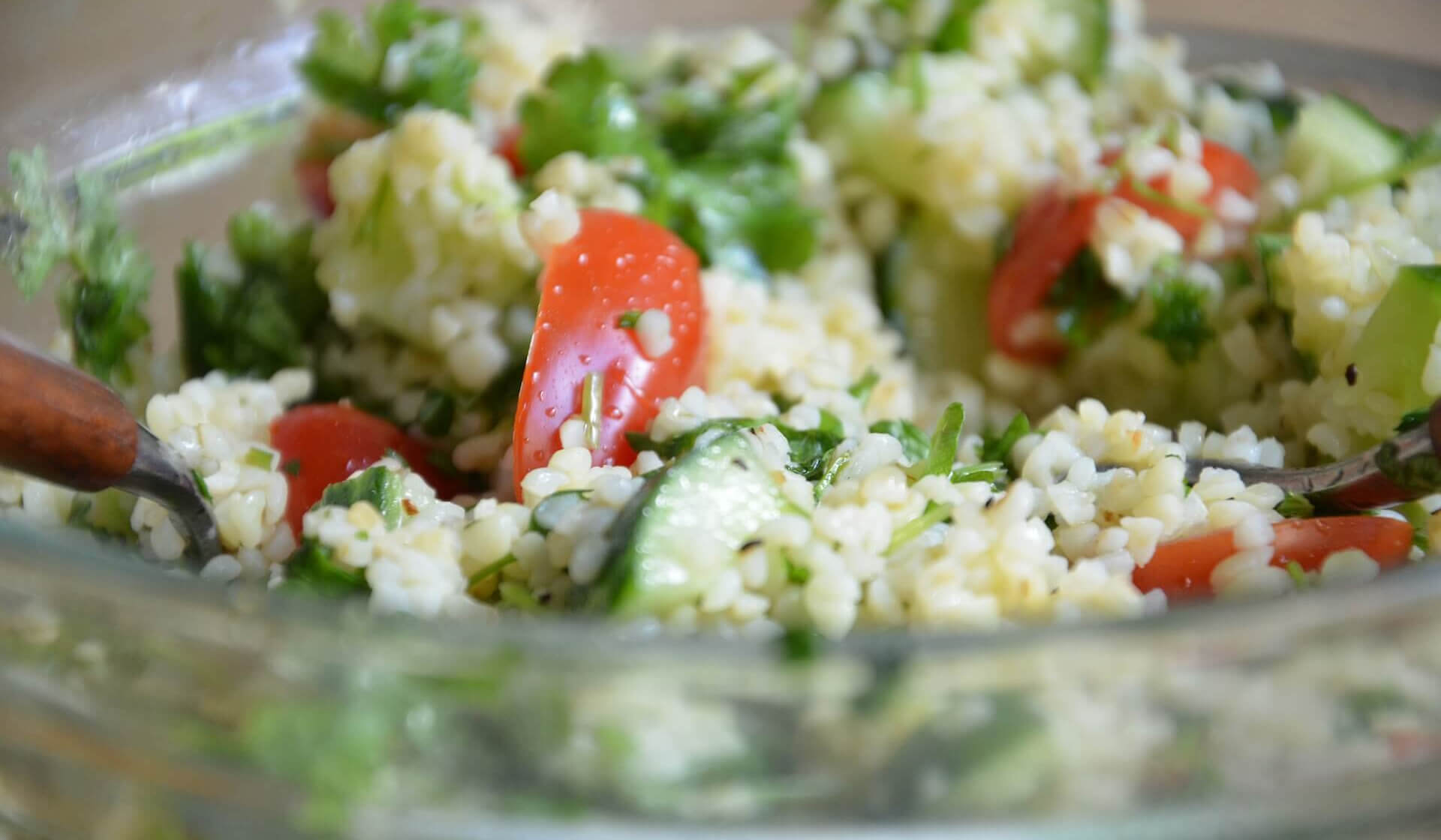 Close up of a Lebanese tabbouleh salad with bulgar wheat, tomatoes, and parsely