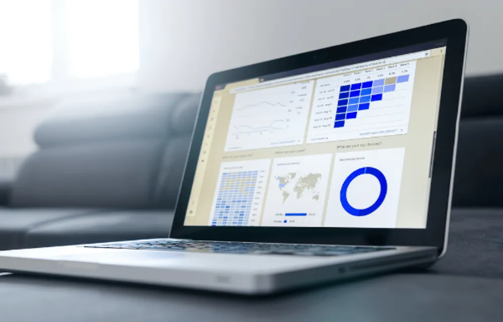 laptop with graphs on the screen