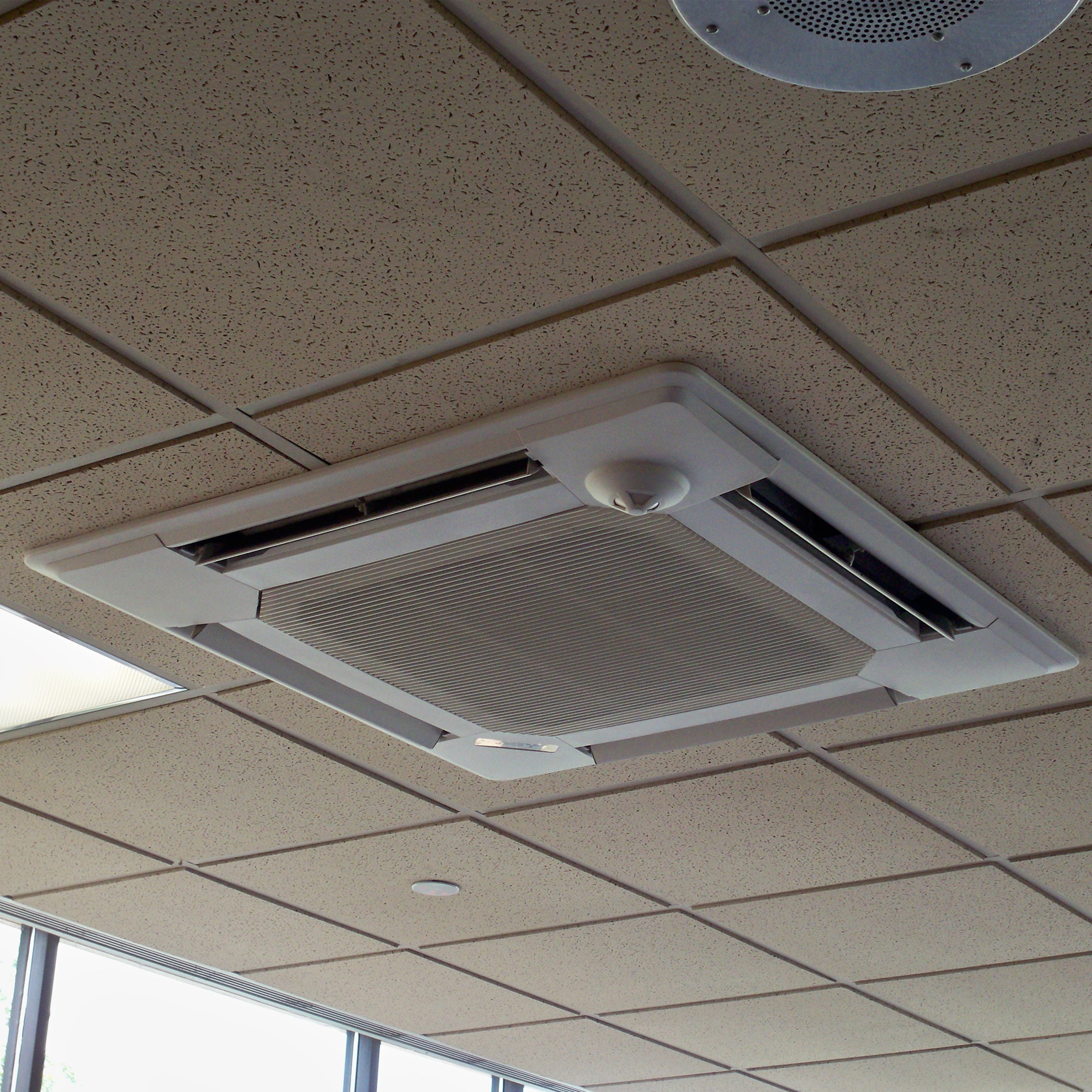 Upgraded HVAC system with ceiling mounted ductless air conditioning and heating units for restaurant dining area