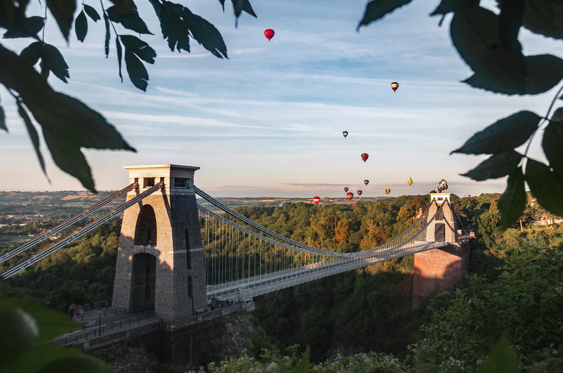 suspension bridge with hot air balloons in the summer