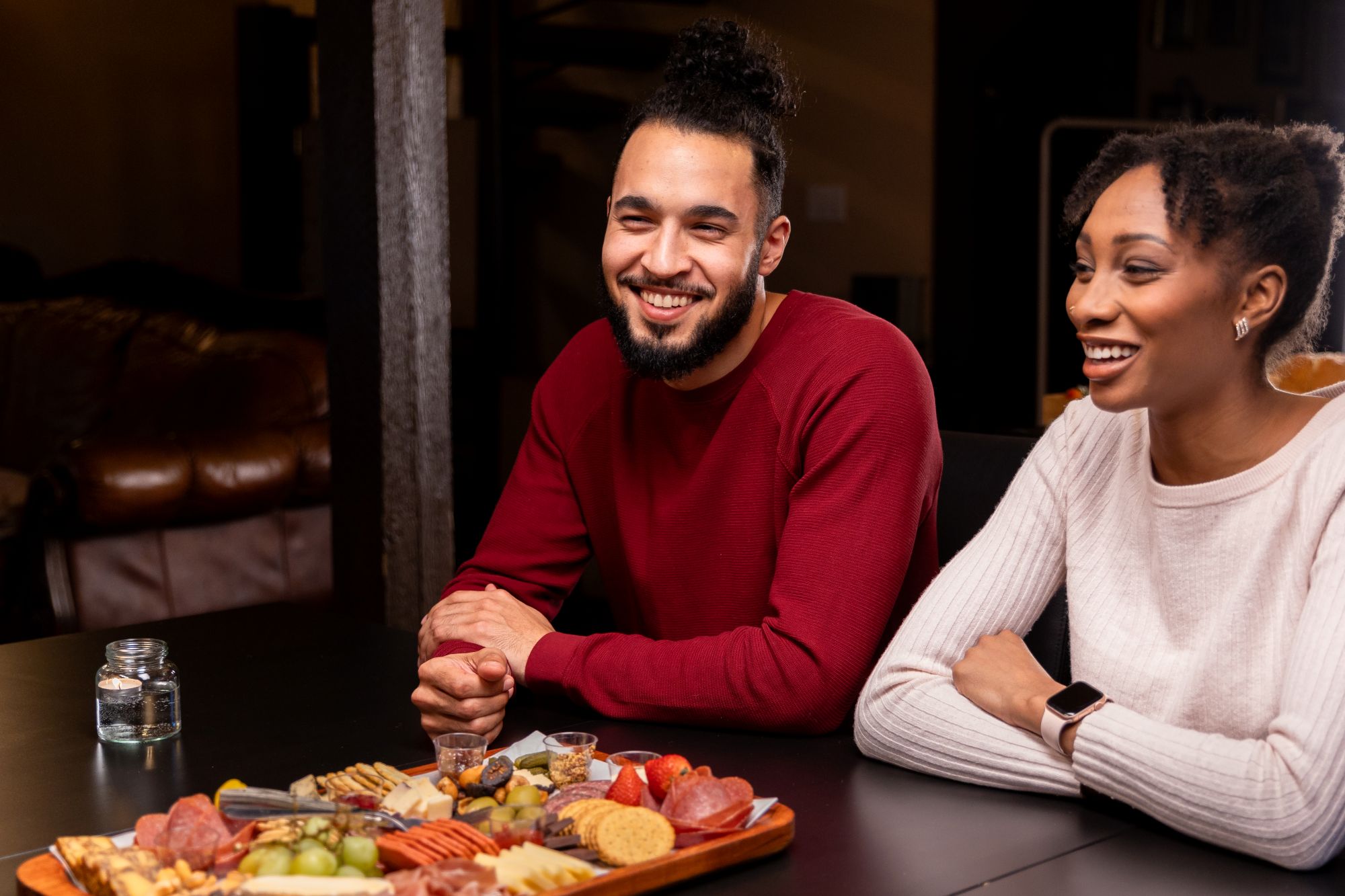 Couple enjoying a charcuterie board. 