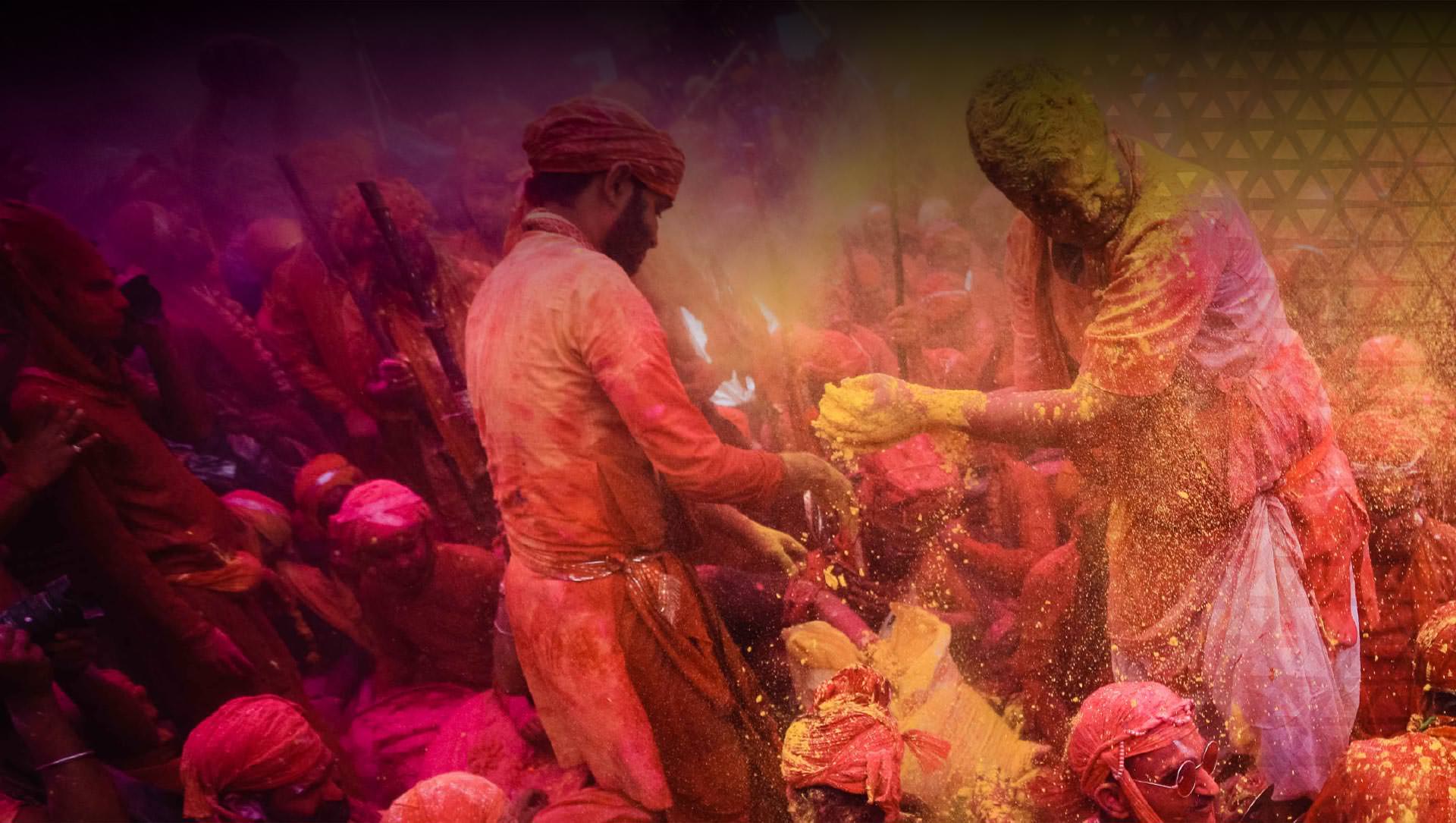 Participants in Holi festival throwing colored powders