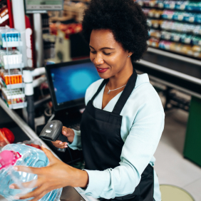 A black female retailer is helping customers check out