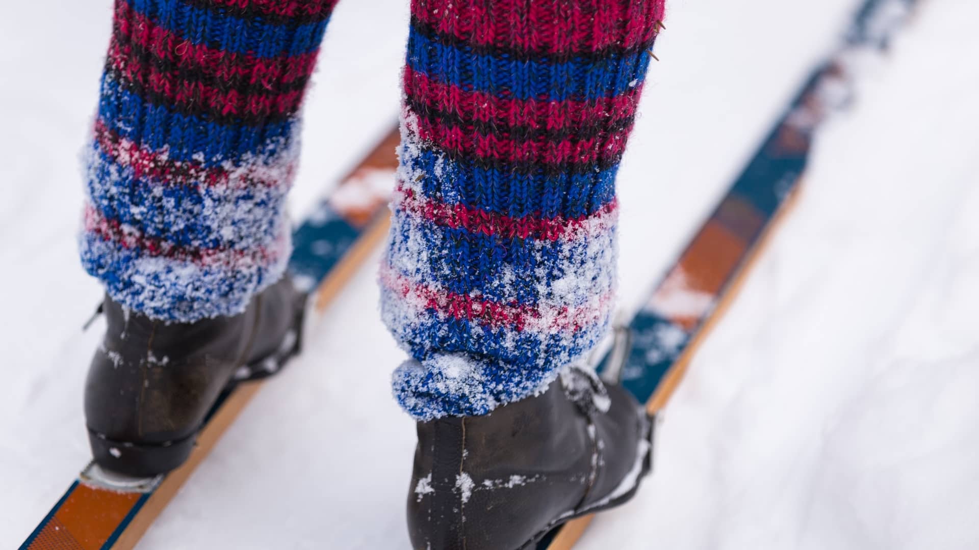 Person wearing heated socks and skis