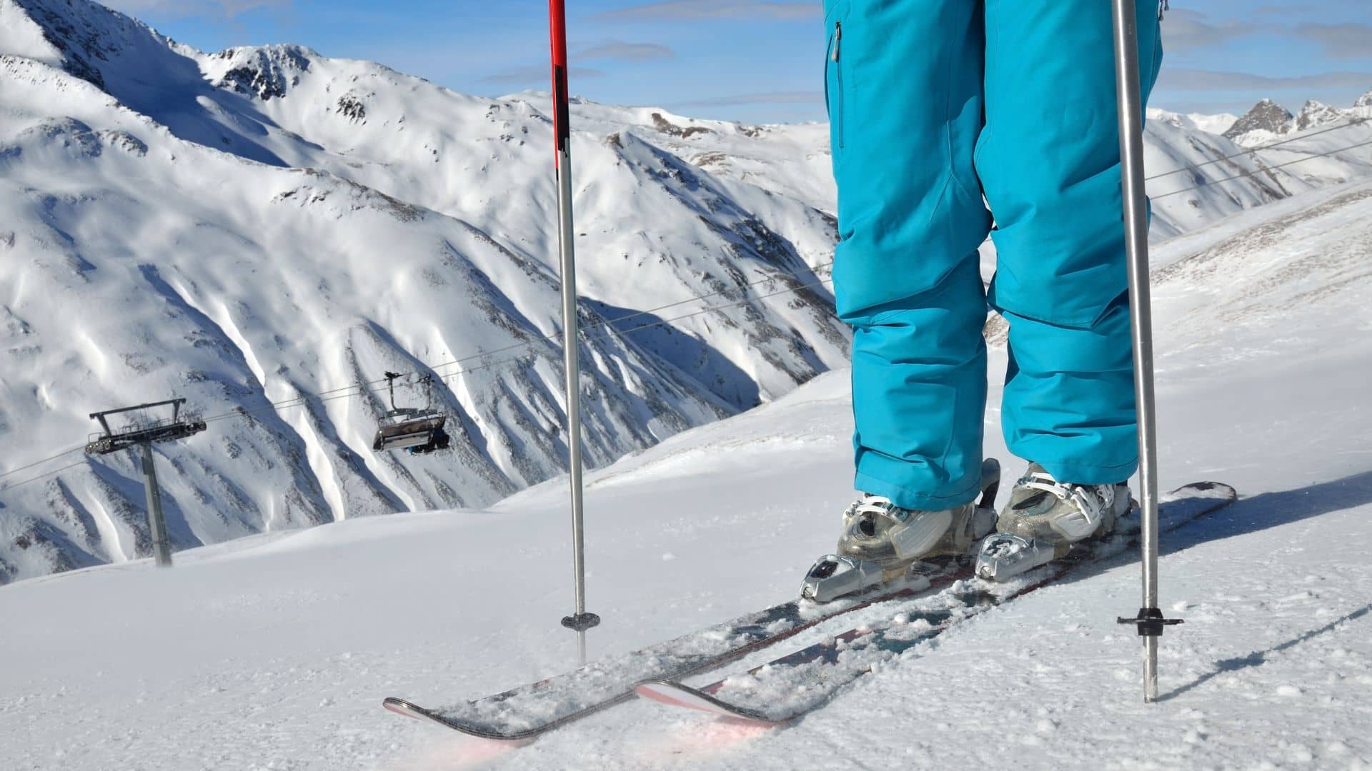 Person wearing ski boots and skis