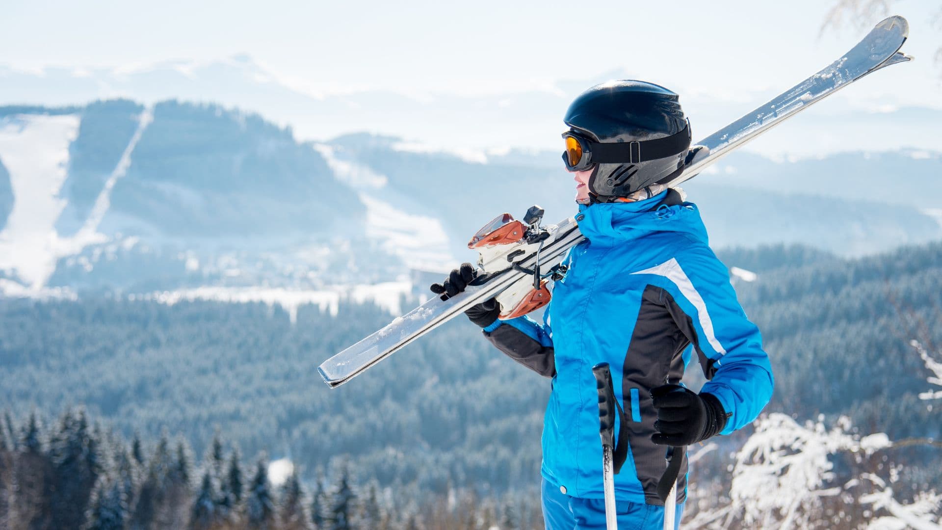 Woman holding skis