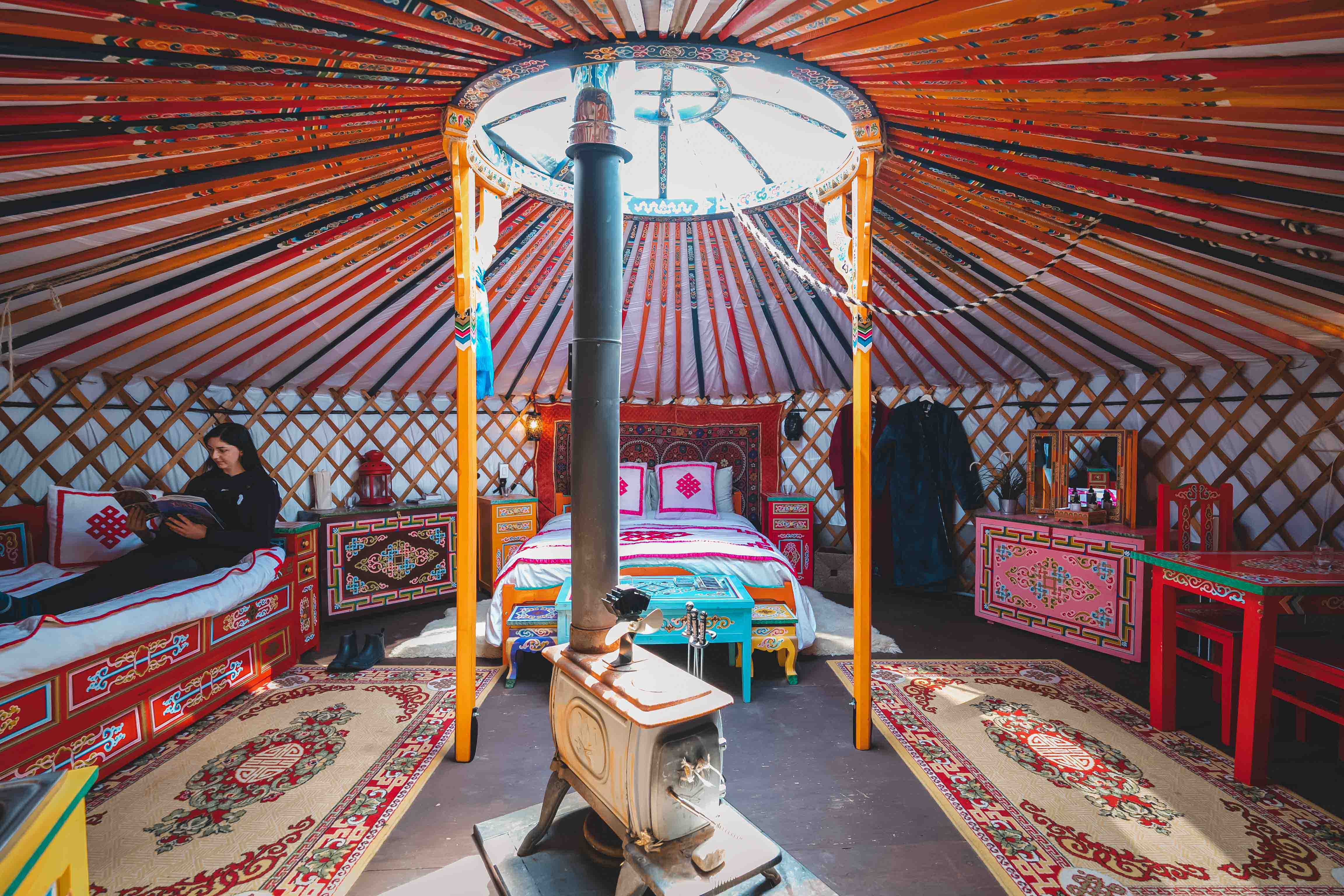 Inside view of fully decorated yurt with beds.