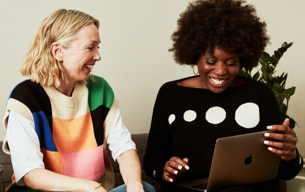 Two carers looking at a laptop