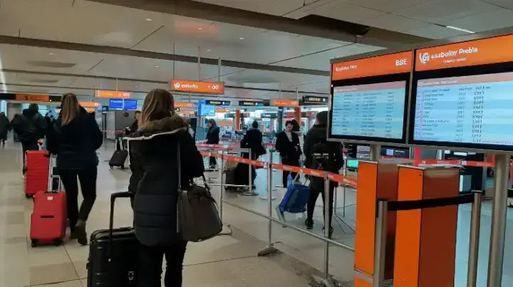 EasyJet baggage fee information chart at airport check-in, showing various costs for different luggage options