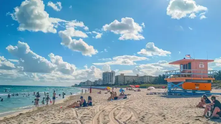 Beachgoers enjoying the sun and sand at South Beach Park, Boca Raton, with iconic lifeguard stand in view