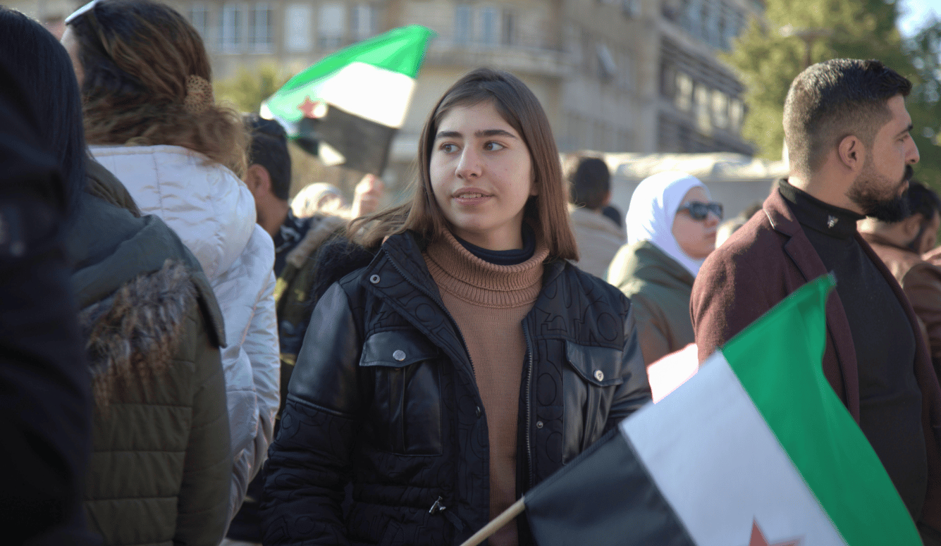 A young woman with a Syrian flag. 