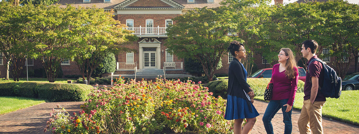 Students chat outside the Classroom Building of Regent University, Virginia Beach.