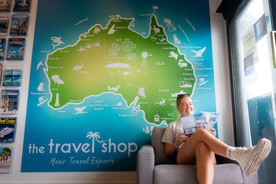 A woman sitting in front of a map of Australia