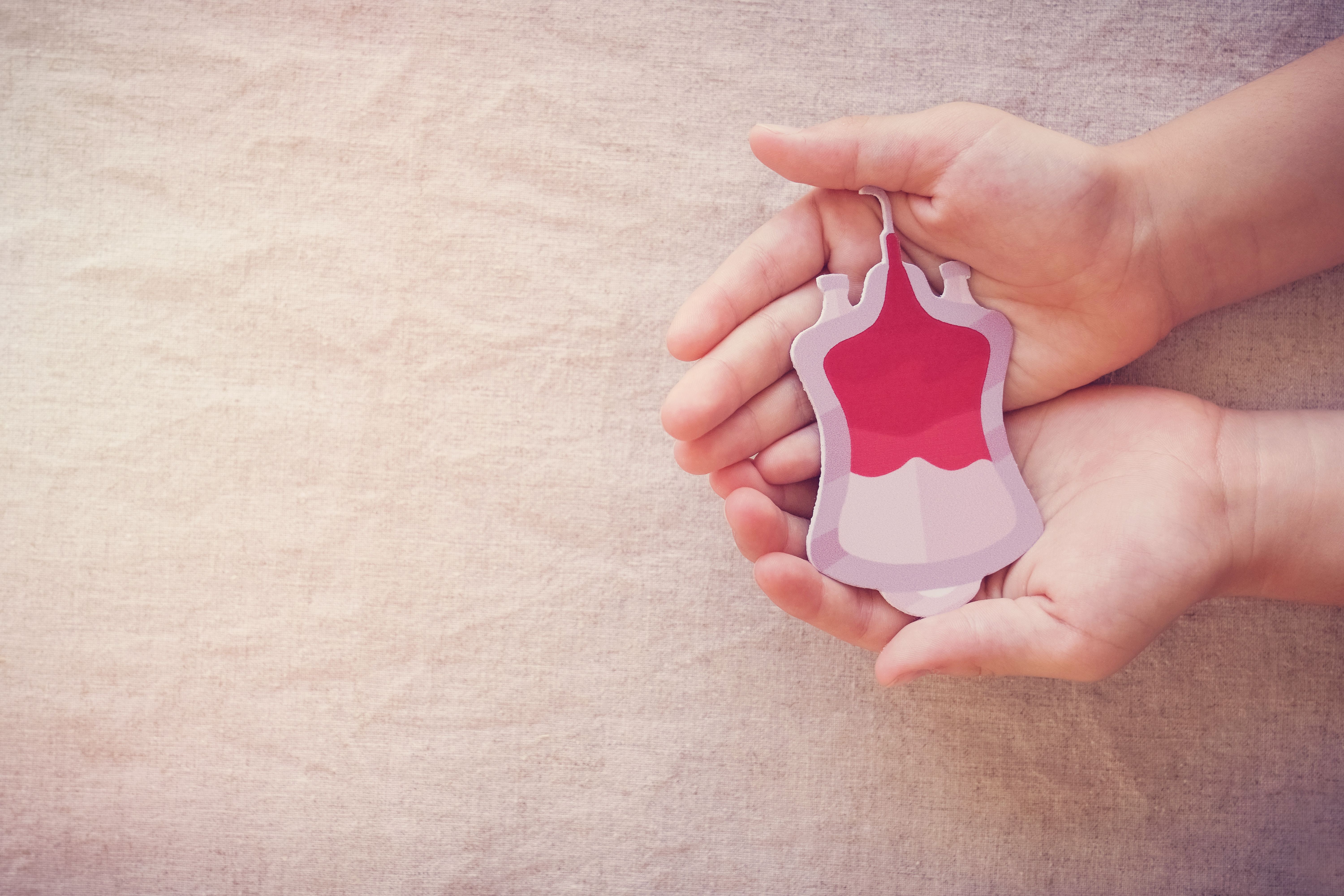 Hands holding blood, give blood donation, blood transfusion, world blood donor day, world hemophilia day concept - SewcreamStudio - stock.adobe.com