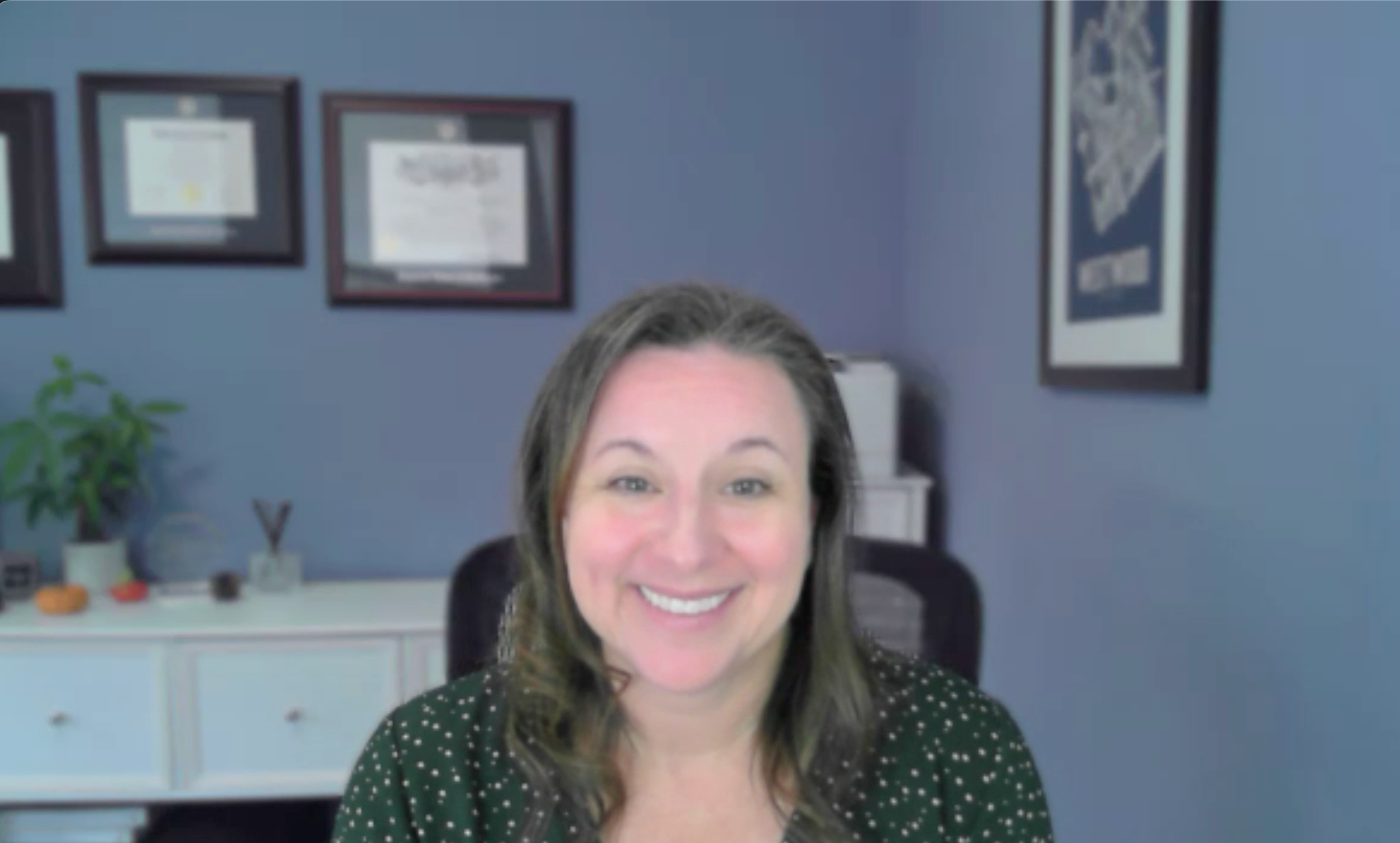 Image of a smiling woman with brown hair. 