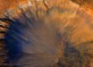 This image of an impact crater in the Sirenum Fossae region of Mars was taken by NASA’s Mars Reconnaissance Orbiter on March 30, 2015. The crater is approximately 3,300 feet (1-km) wide and appears relatively recent as it has a sharp rim and well-preserved ejecta. The steep inner slopes are carved by gullies and include possible recurring slope lineae on the equator-facing slopes. Image credit: NASA / JPL / University of Arizona / Alfred McEwen.