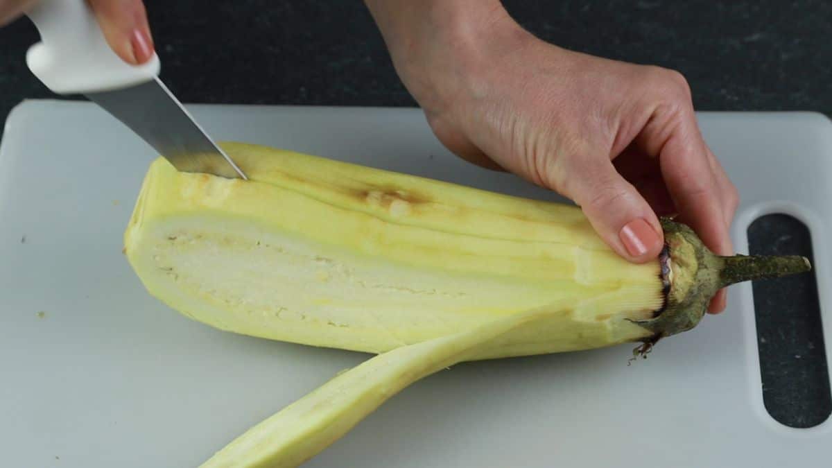 knife cutting eggplant into strips