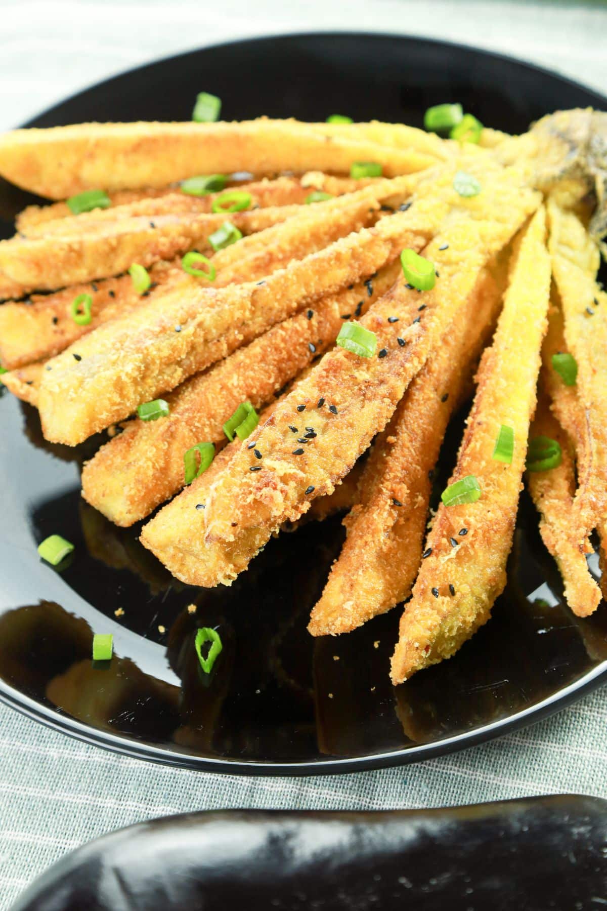 fried eggplant blossom on round black plate