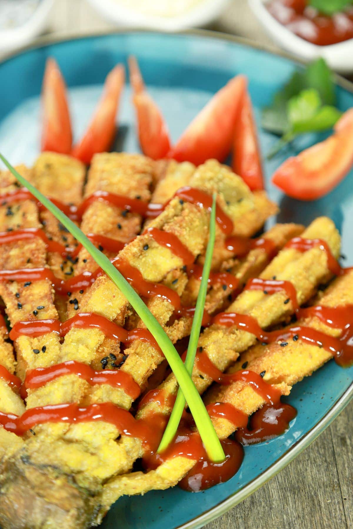 fried eggplant with ketchup on top