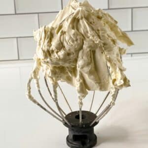 semi homemade buttercream on beater sitting on counter