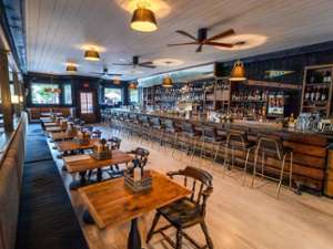 rustic tables in a restaurant dining area and a bar space