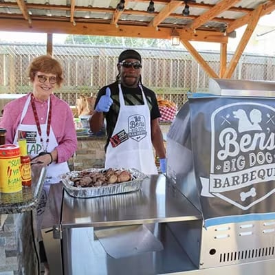 Ben's Big Dog Barbecue team showing off a tray of food