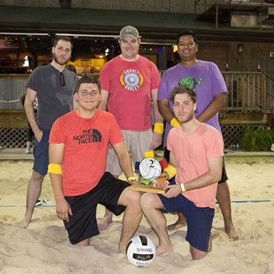 BBQGuys employees showing off a second place volleyball trophey