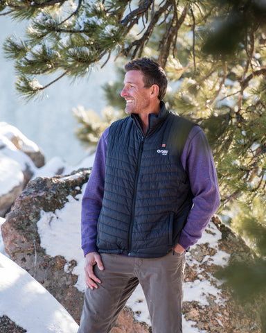 Man wearing black Gobi Heat Dune vest outdoors in the snow