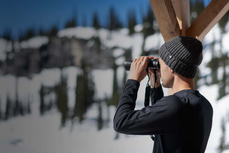 Man wearing Heat Holders thermal baselayers, and using binoculars