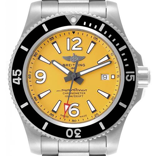 The Breitling Superocean watch is shown from the front, displaying its yellow dial, bezel, hands, numerals, and part of the bracelet.