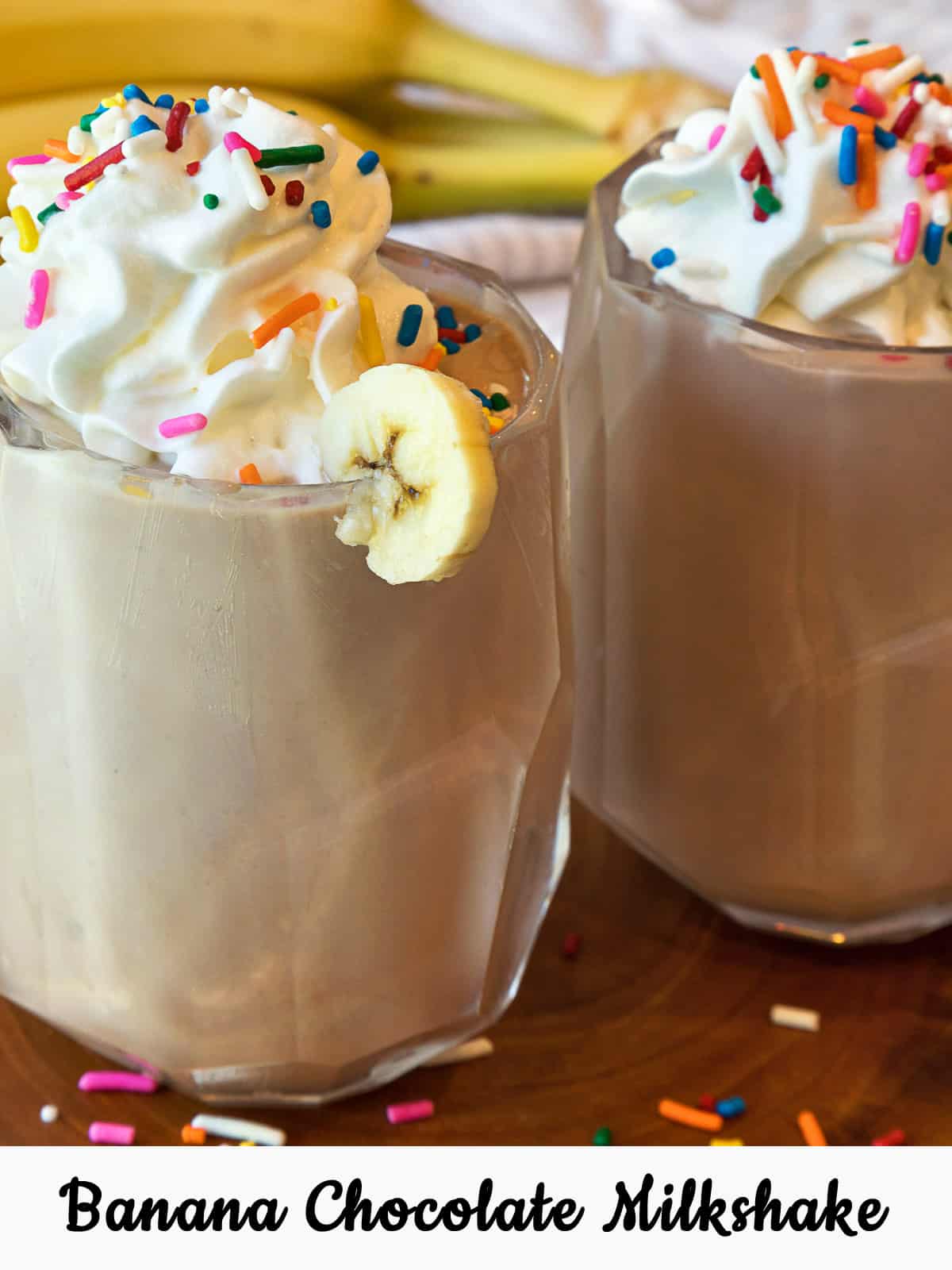 Banana chocolate milkshake with whipped cream and sprinkles.