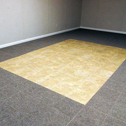 Carpeted basement floor tiles installed on a concrete slab floor.