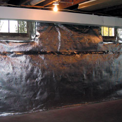 Carpeted basement floor tiles installed on a concrete slab floor.