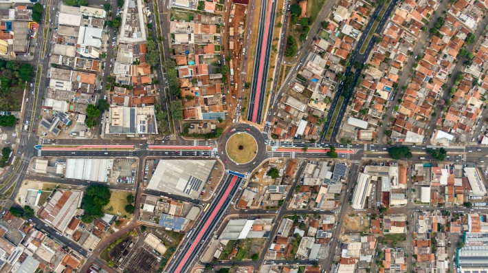 Drone shot of a roundabout and houses in a city 