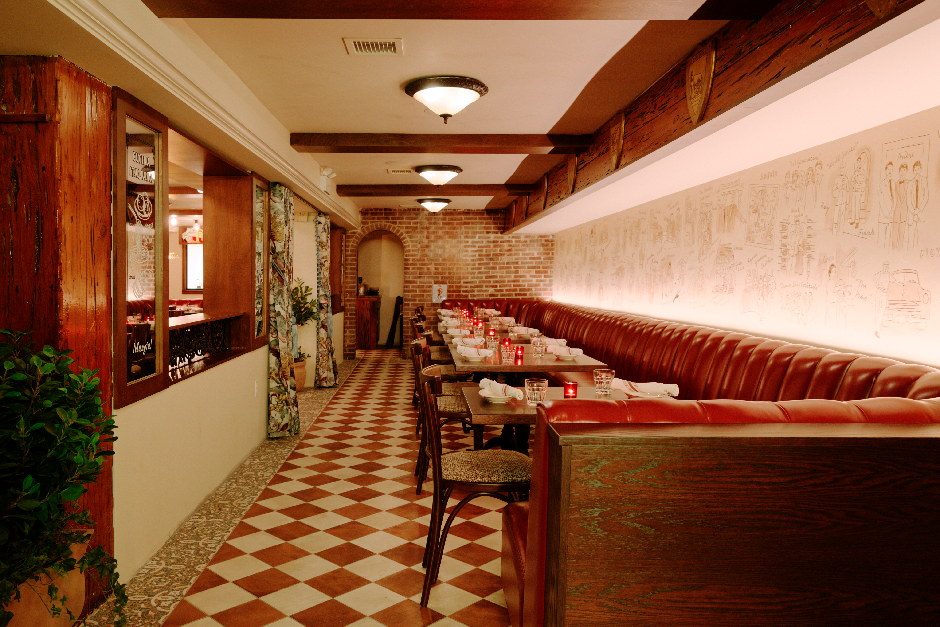 The long narrow interior at Sotto has leather banquettes and hand-drawn wallpaper.