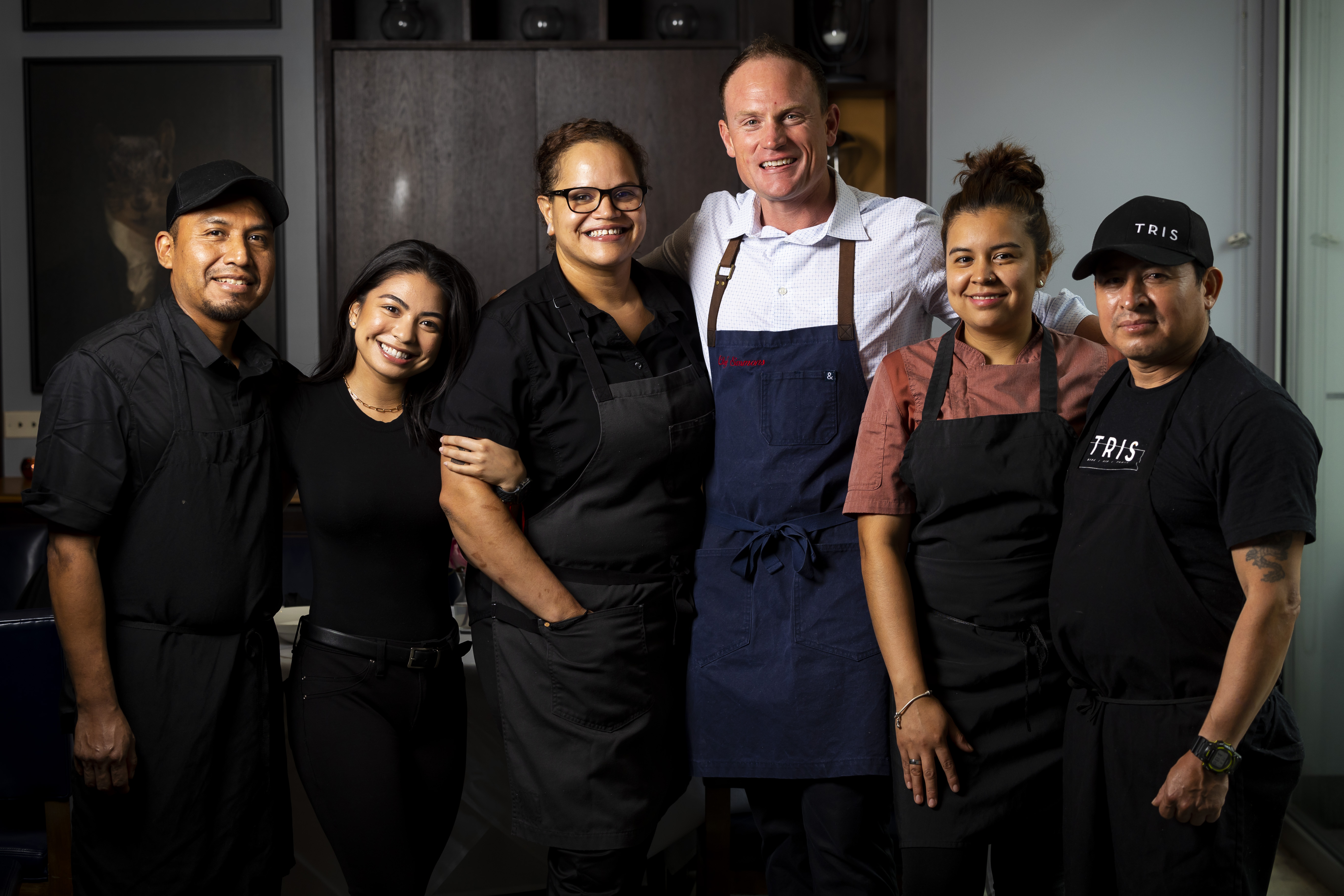 Chef Austin Simmons, center, and his culinary team at Tris.