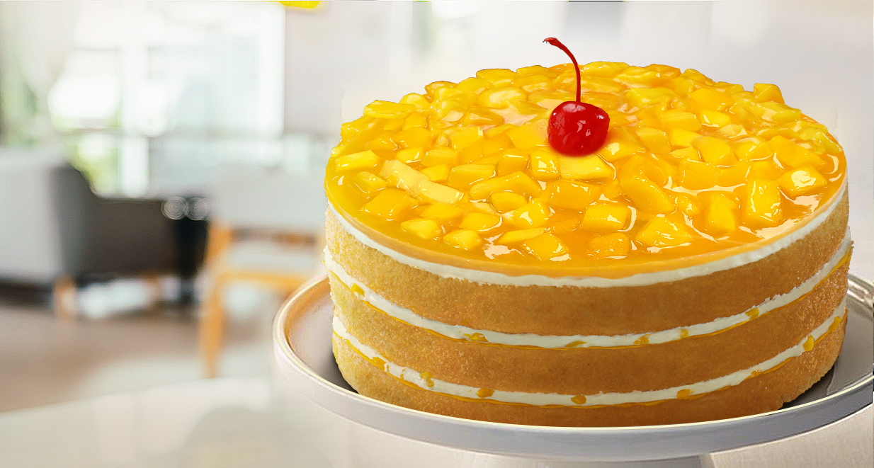 A three-layer mango supreme cake from Filipino bakery chain Red Ribbon Bakeshop, topped with a red cherry.