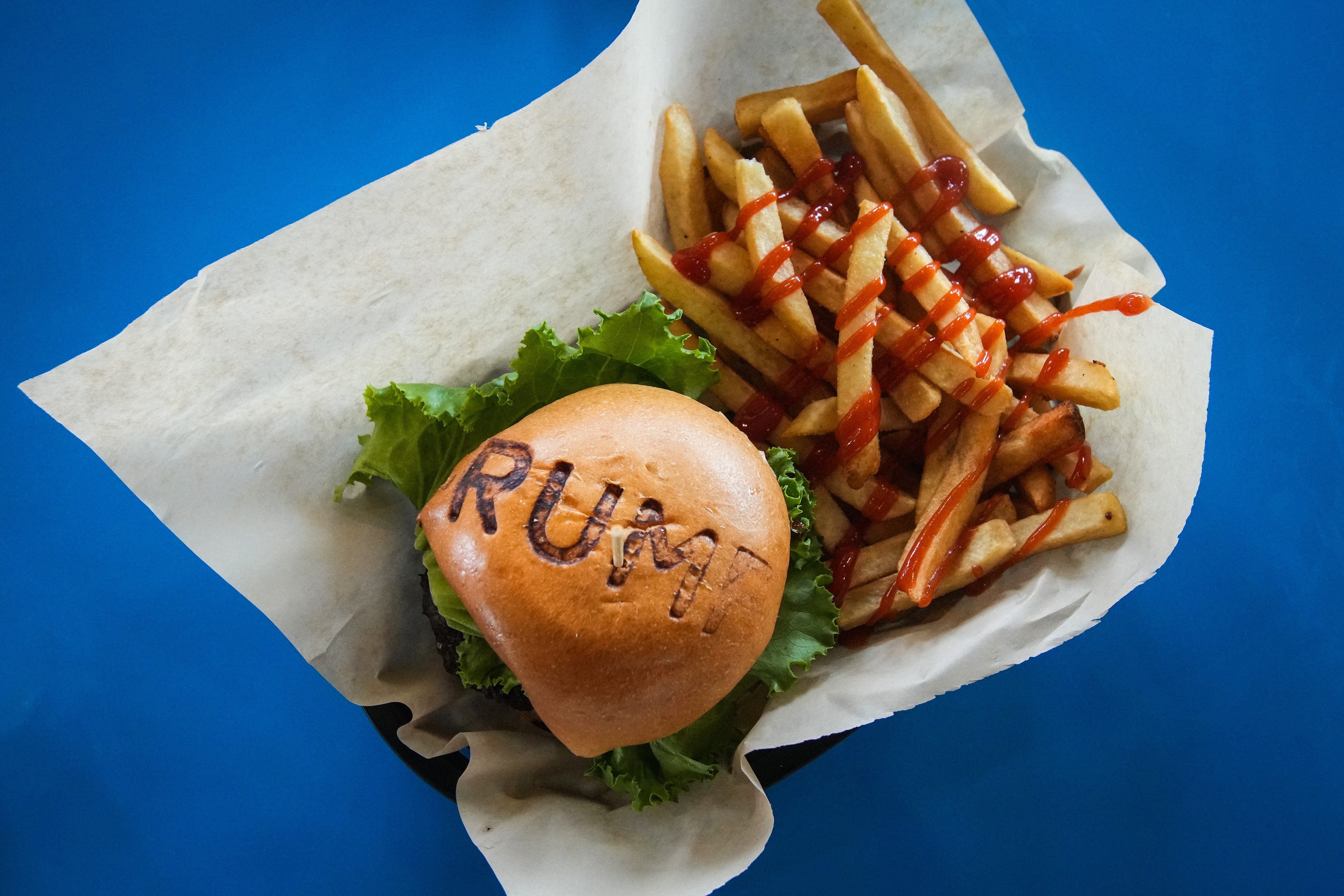 Trump” is toasted on the hamburger buns during lunch at Trump Burger Thursday, July 28, 2022 in Bellville.