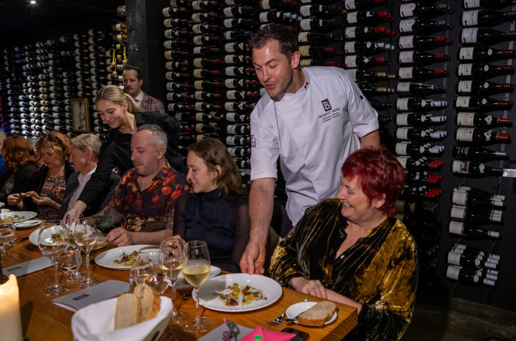 Dominic Fortin serving his creations in the wine cellar of the Bearfoot Bistro.