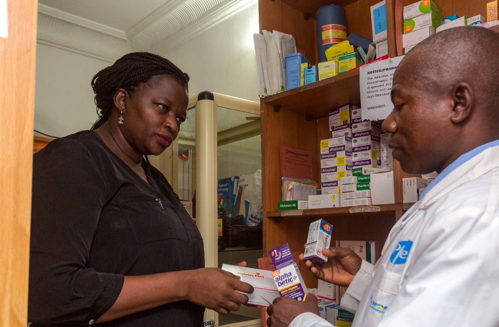 Woman picks up her diabetes medications at a pharmacy in Lagos