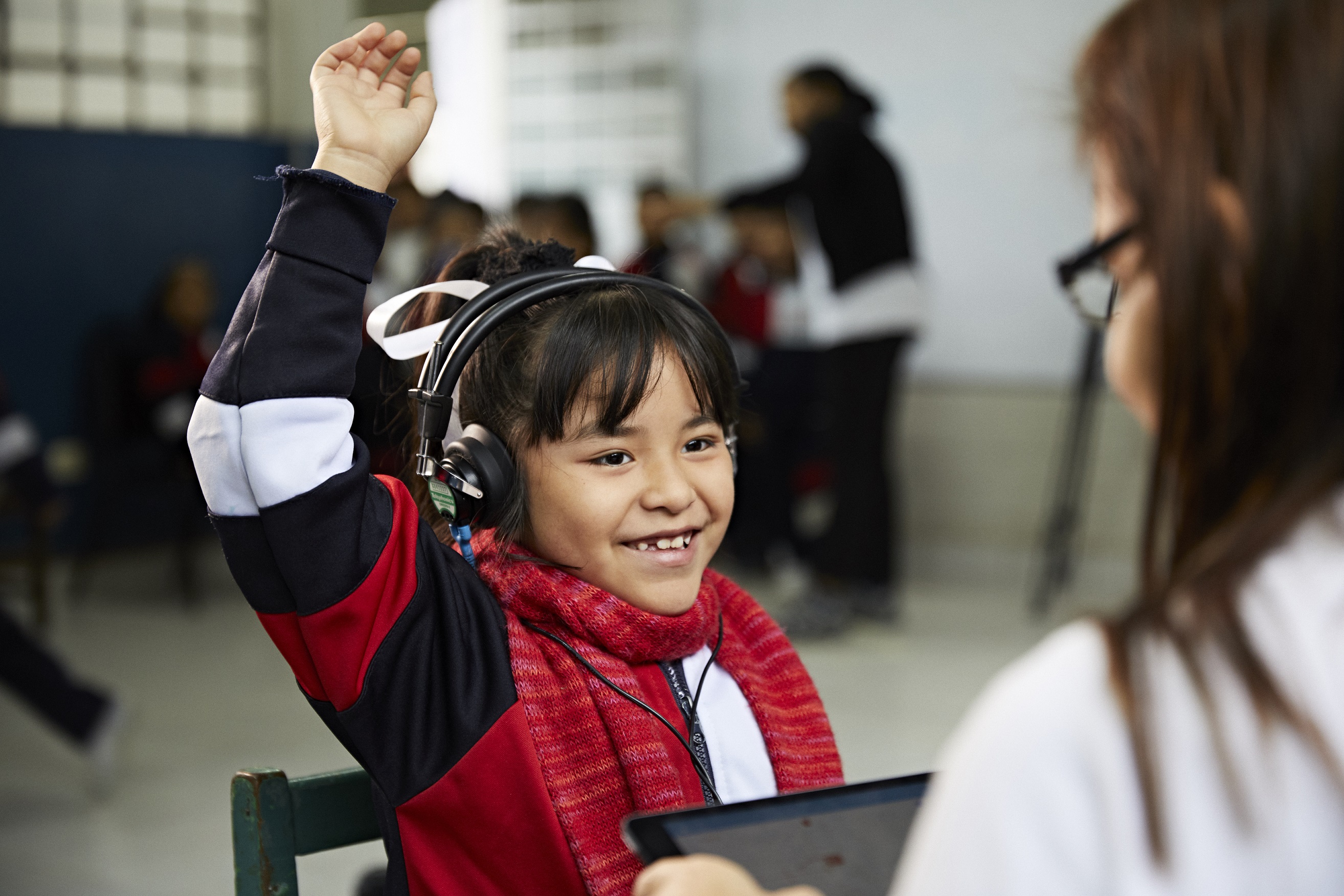 child rasing hand deafness hearing loss