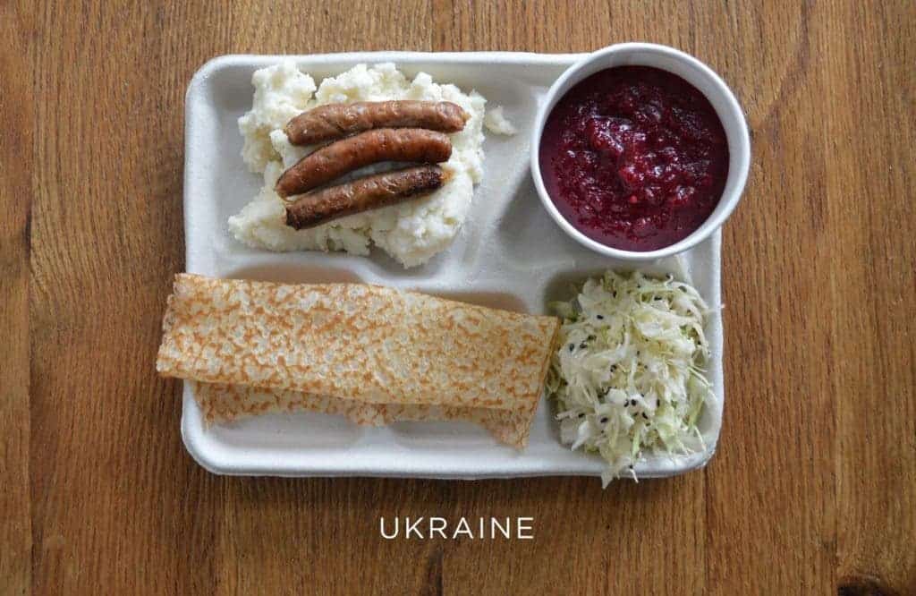 Mashed potatoes with sausage, borscht, cabbage and syrniki (a dessert pancake).